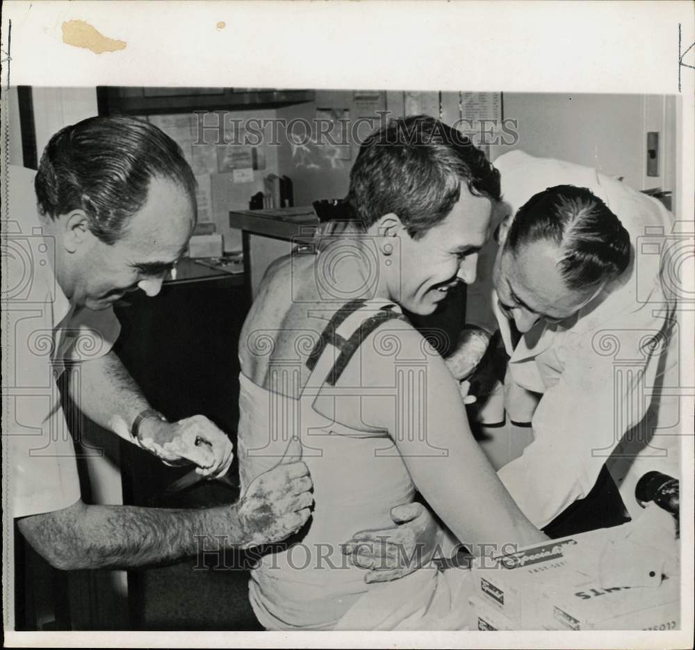 1965 Press Photo Football player Frank Ryan wrapped up by doctor, official- Historic Images