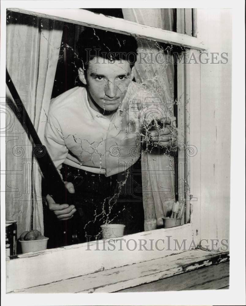 1966 Press Photo Larry Rubeck checks hole in window made when he fired rifle, PA- Historic Images