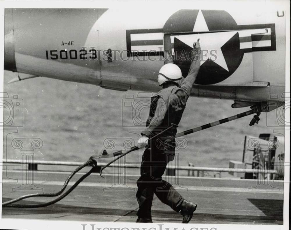 1968 Press Photo Aircraft carrier crewman signals to a pilot on deck - kfx16781- Historic Images