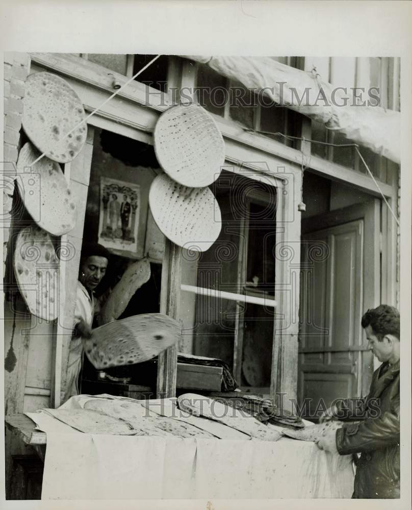 1959 Press Photo Iranian unleavened water-bread tossed on counter for sale.- Historic Images