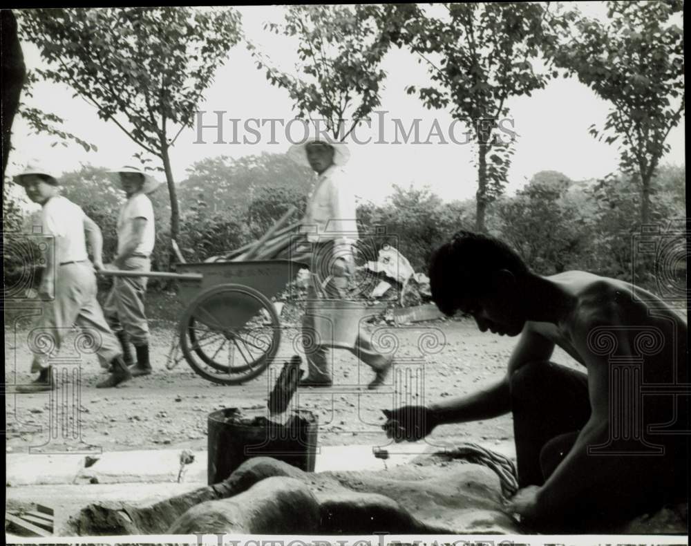 1965 Press Photo Workmen Stare at Artist Tomio Miki Shaping a Giant Ear- Historic Images