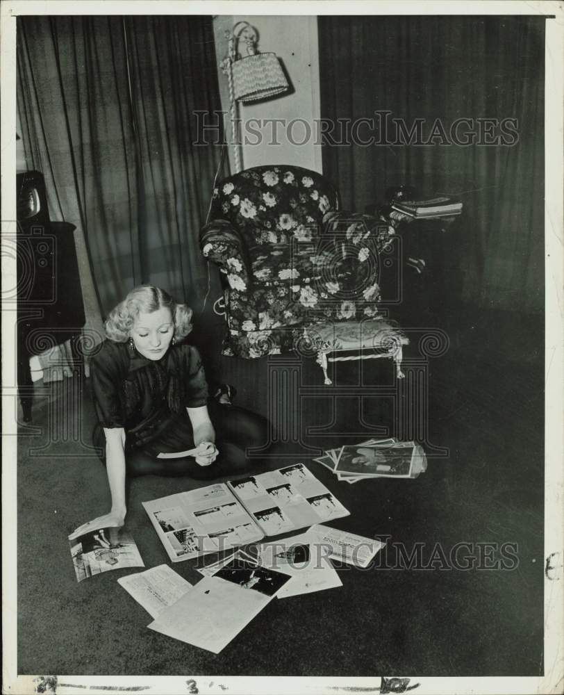 1951 Press Photo Movie stand-in Ruby Wood works on her scrapbook - kfx46676- Historic Images