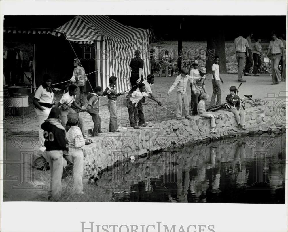 1978 Press Photo Youths go fishing by the water at Festival in the Park in NC- Historic Images