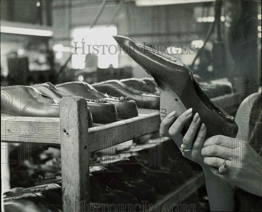 1961 Press Photo A worker inspects a Marcie shoe at the warehouse - lra17381- Historic Images