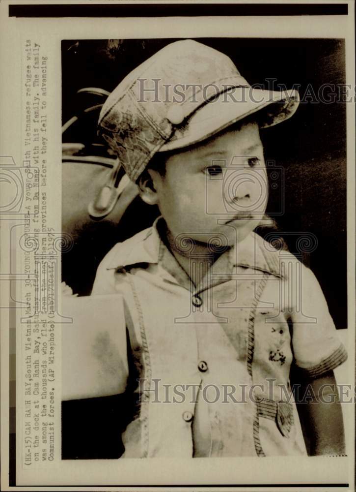 1975 Press Photo Young South Vietnamese refugee waits on dock at Cam Banh Bay- Historic Images