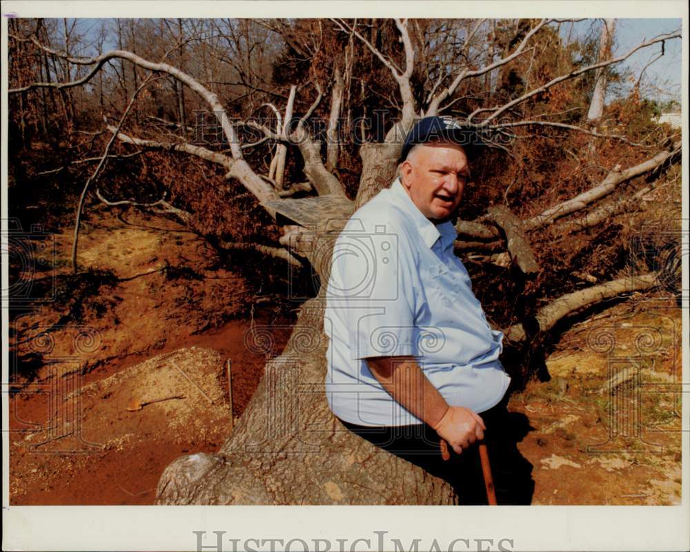 1990 Press Photo Tom Blank sits on the fallen tree in Union County - lra19191- Historic Images