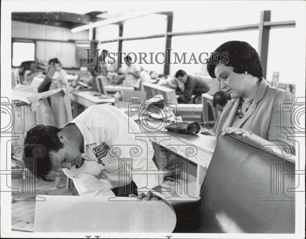 1967 Press Photo Mrs. Lois Baker watches as Bill Caudill works in leather plant- Historic Images