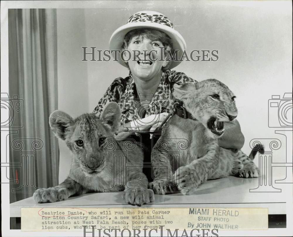 1967 Press Photo Beatrice Dante poses with the lion cubs at Lion Country Safari- Historic Images