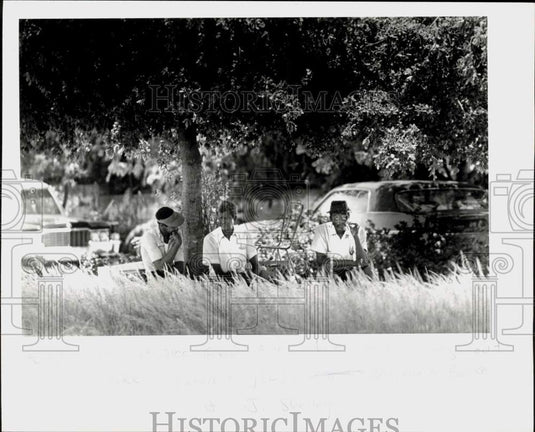 1979 Press Photo Men sit at the site of proposed mini park in Coconut Grove- Historic Images