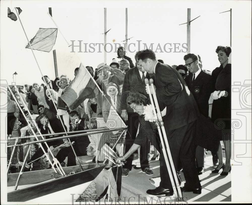 1965 Press Photo Mrs. Homer Denius swings bottle on bow to christen Maredea ship- Historic Images