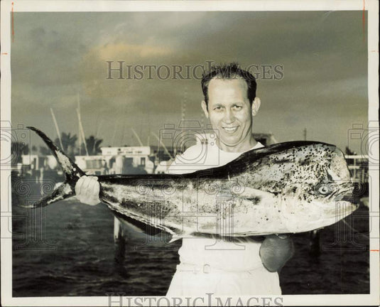 1957 Press Photo Joseph Melencheck holds bull dolphin at Miami fishing contest- Historic Images