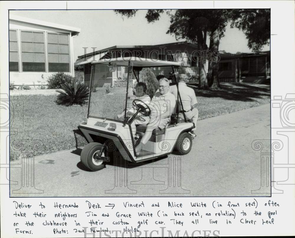 1986 Press Photo Residents of Cloverleaf Farms ride a golf cart to the pool- Historic Images