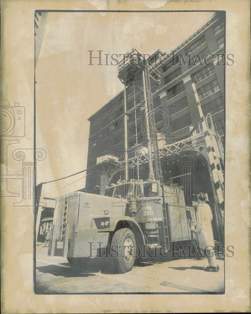 1976 Press Photo Donald Walsh watches as workmen raise tower on emergency truck- Historic Images