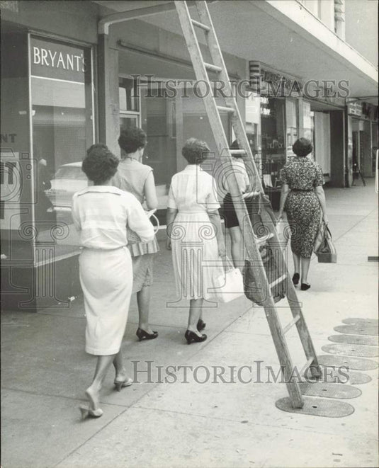1959 Press Photo Ladies walking under ladder on 