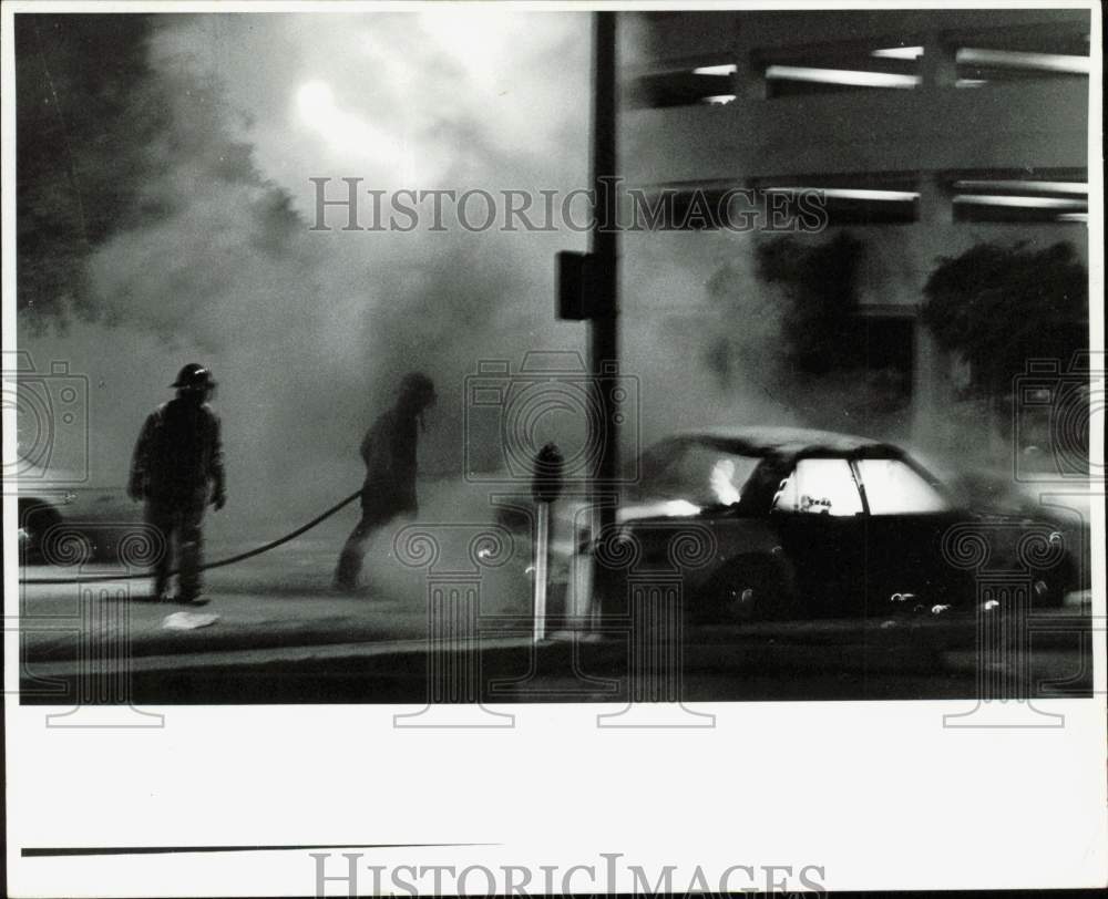 Press Photo Car burns near Public Safety Headquarters during racial demo, FL- Historic Images