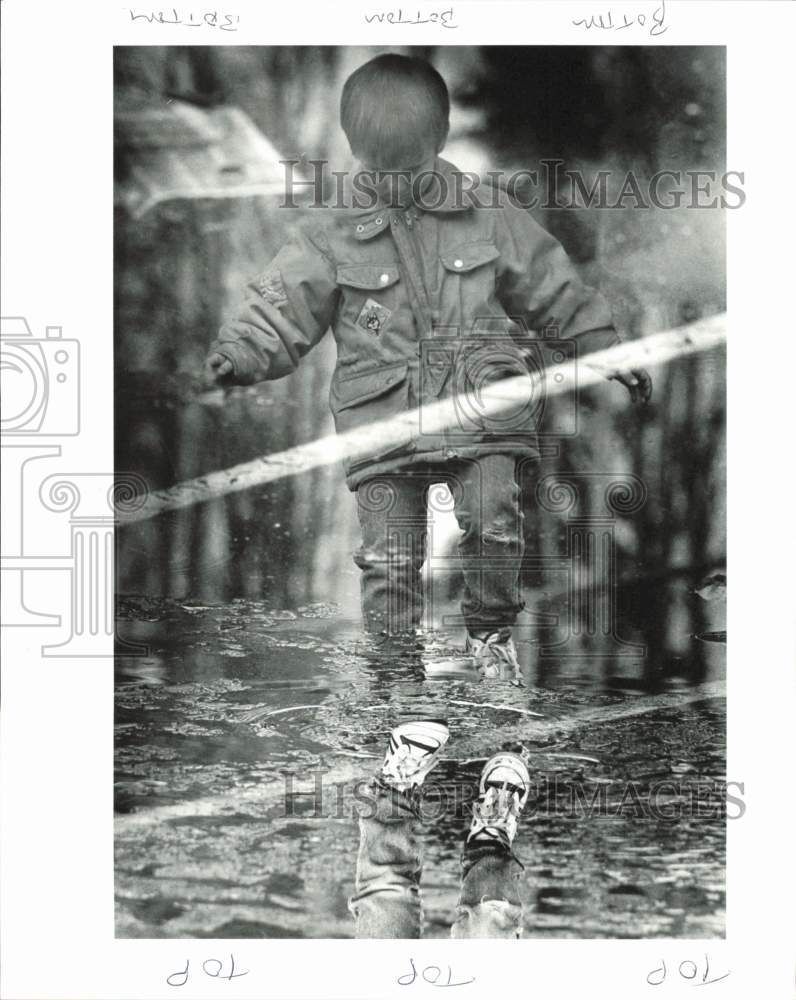 1989 Press Photo Adam Shaughnessy tiptoes through water at Homestead School- Historic Images