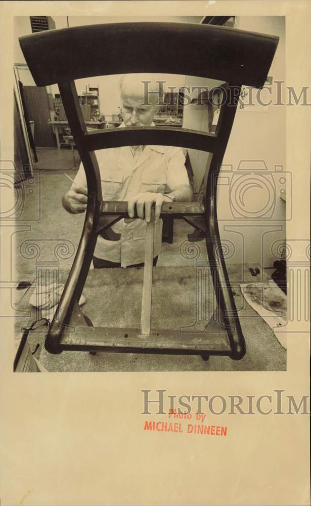 1985 Press Photo Man working on restoring an antique chair at The Windmill- Historic Images