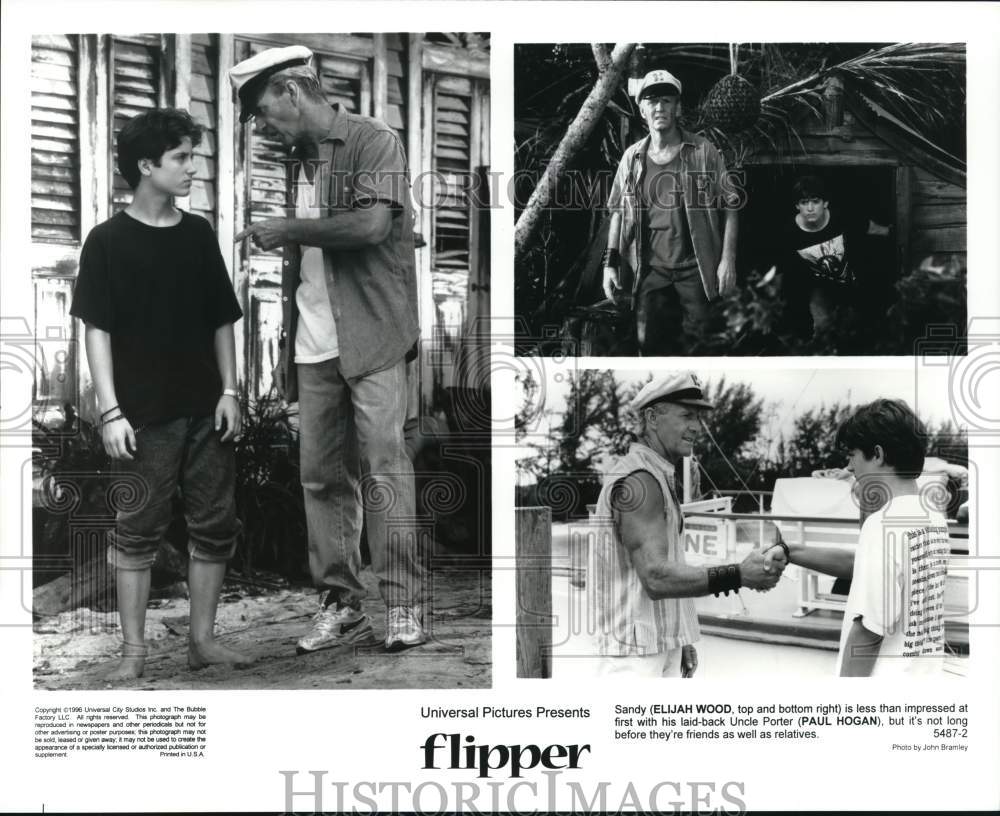 1996 Press Photo Elijah Wood and Paul Hogan in scenes from &quot;Flipper.&quot;- Historic Images