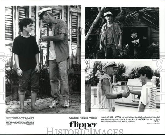 1996 Press Photo Elijah Wood and Paul Hogan in scenes from "Flipper."- Historic Images
