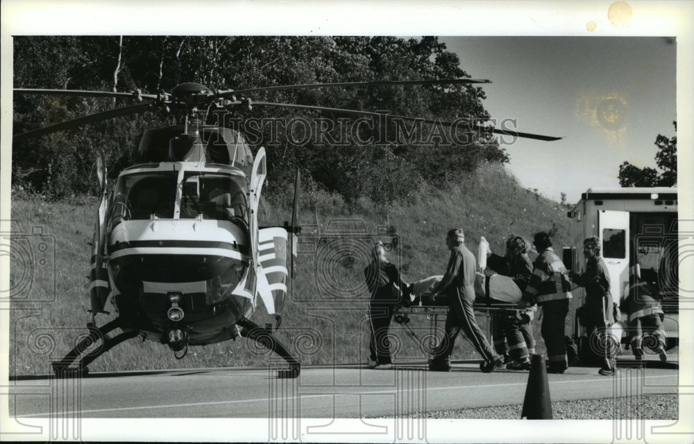 1994 Press Photo Michael J. Rogalski to Flight for Life Helicopter from Accident- Historic Images