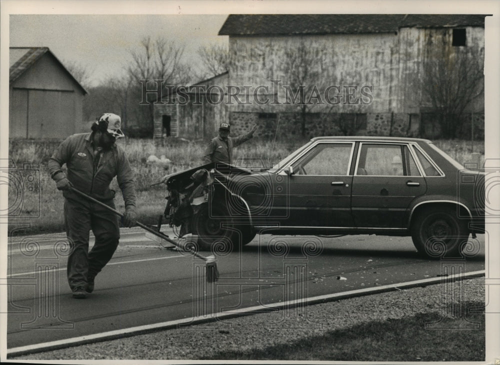 1988 Press Photo Worker swept broken glass from car-bus collision at Mukwonago- Historic Images