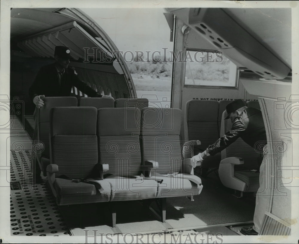 1966 Press Photo Two workers unlock planes&#39;s seat which are on carpeted pallets- Historic Images