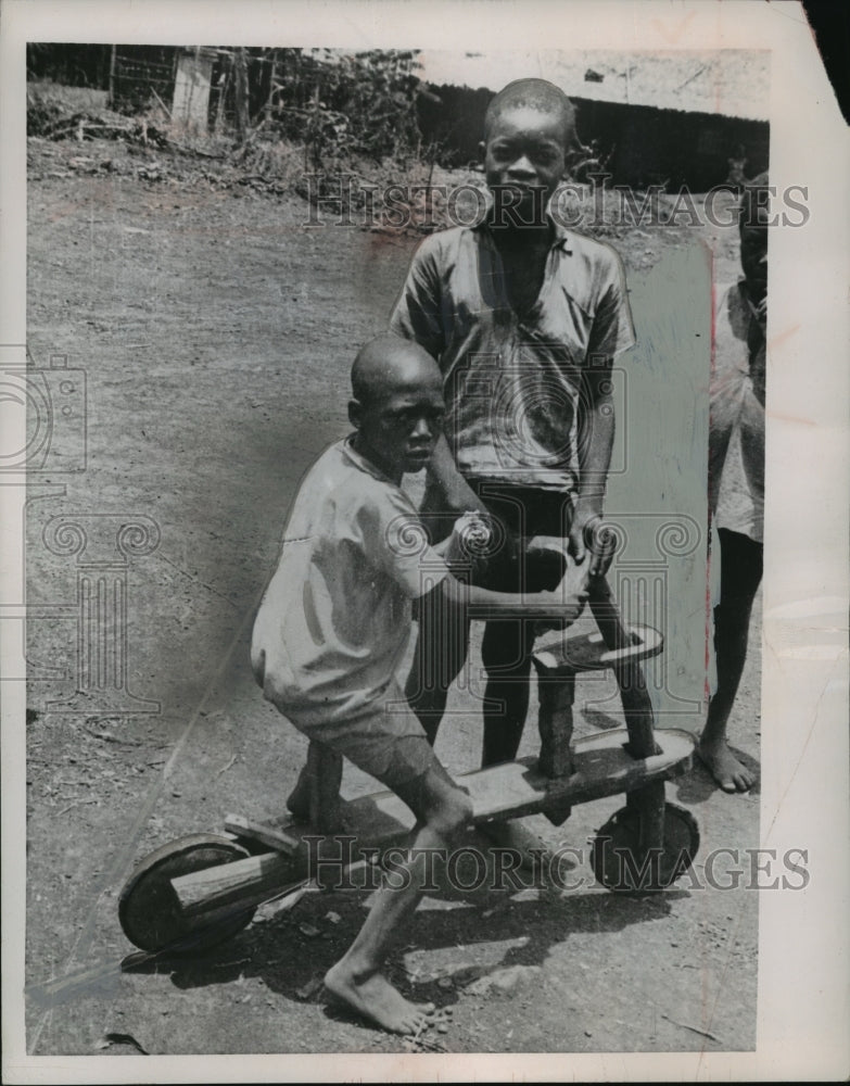1955 Press Photo Youngsters playing with a scooter made from wood - mja02479