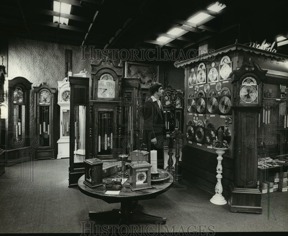 1981 Press Photo A visitor at the factory showroom viewed the variety of clocks- Historic Images