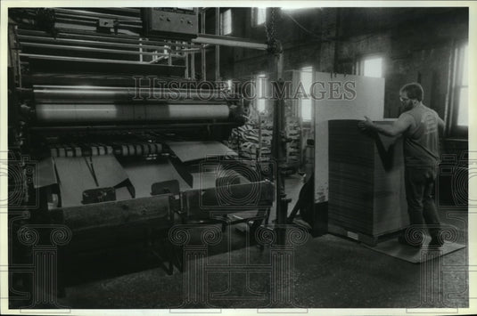1968 Press Photo Terry Wiese stacks newly manufactured paperboard - mja06163