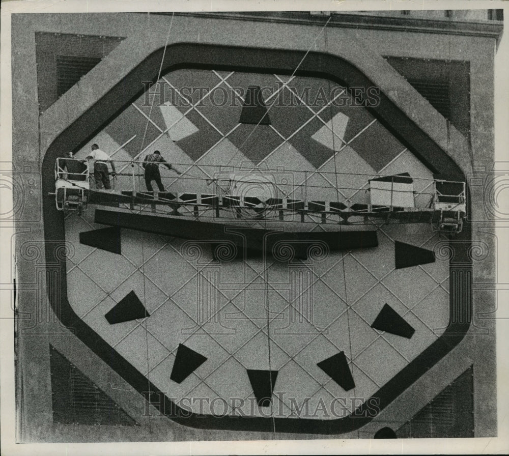 1968 Press Photo Workmen are busy replacing the darker panels on the clock