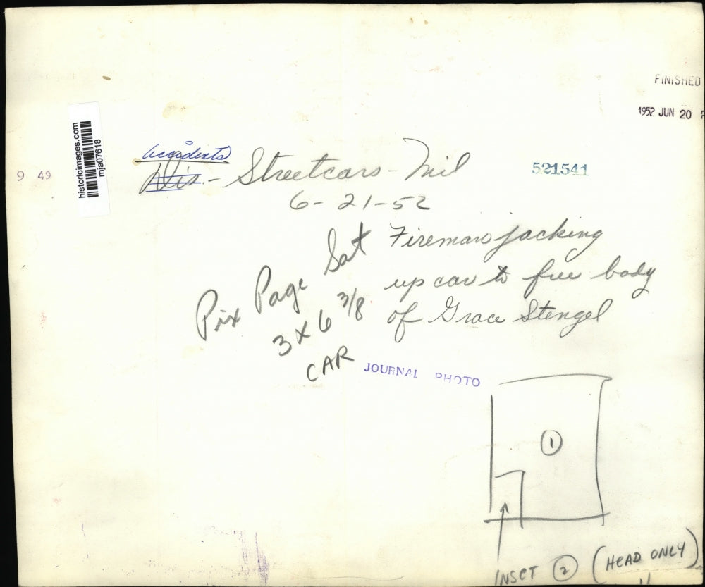 1952 Press Photo Fireman jacking up car to free body of Grace Stengel