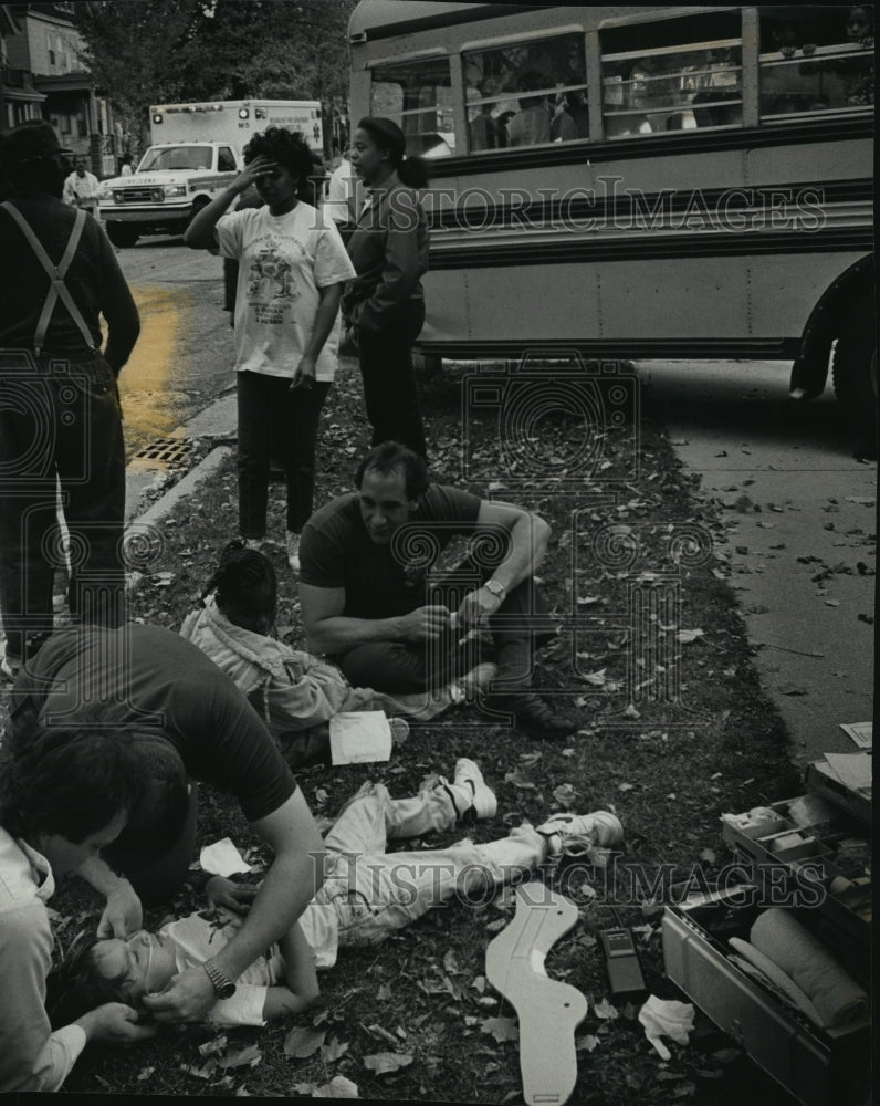 1991 Press Photo Workers comfort victims of bus-car collision near W. Galena- Historic Images