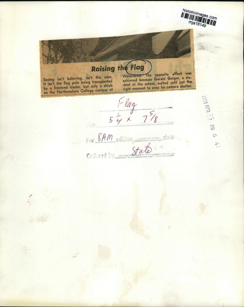 1951 Press Photo A shrub being transported at Watertown while it passes a flag