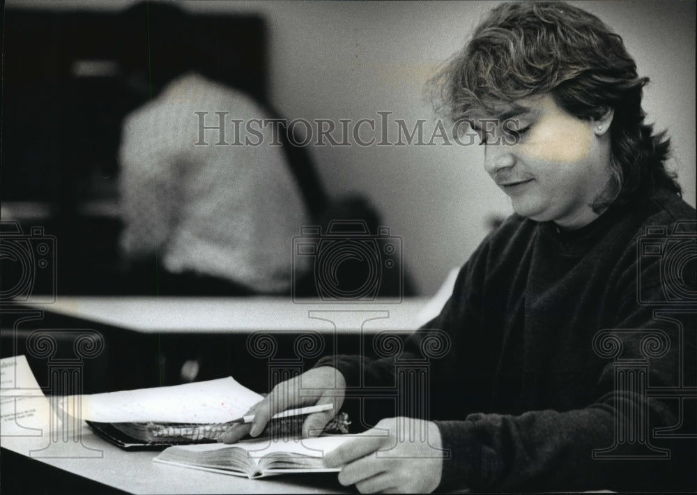 1992 Press Photo Kevin Fanbel does some work in a textbook about social problems- Historic Images