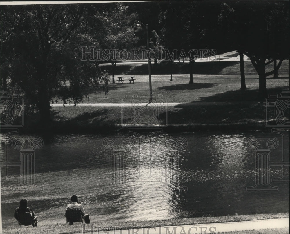 1988 Press Photo Fishing, a relaxing pastime beside McCarty Park's waters