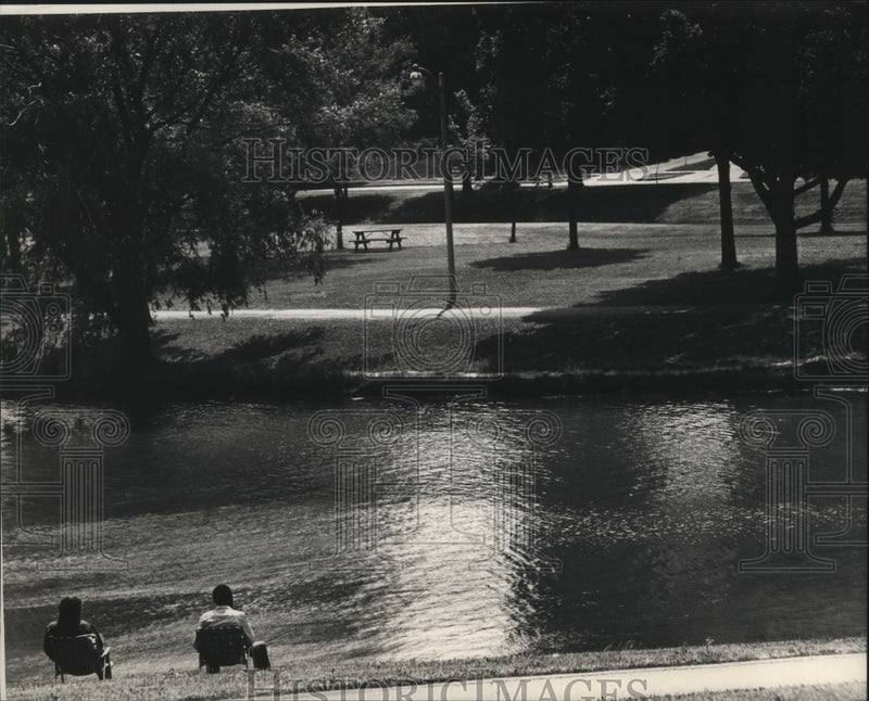 Load image into Gallery viewer, 1988 Press Photo Fishing, a relaxing pastime beside McCarty Park's waters
