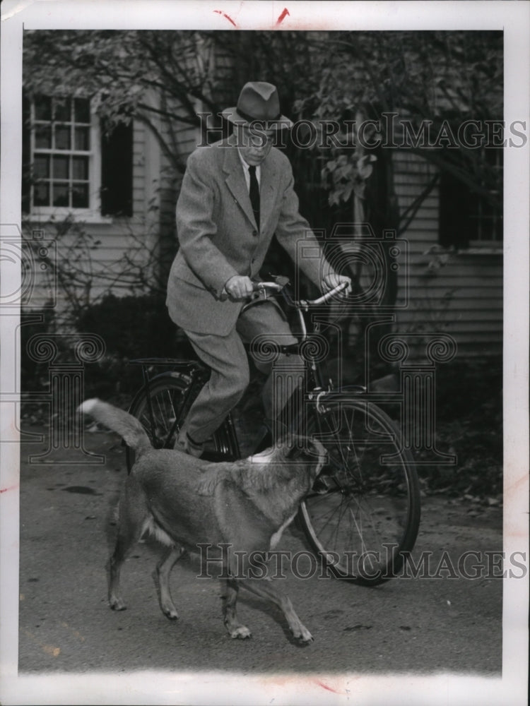 1955 Press Photo Dr Paul Dudley White rides on a bicycle from his home. - Historic Images