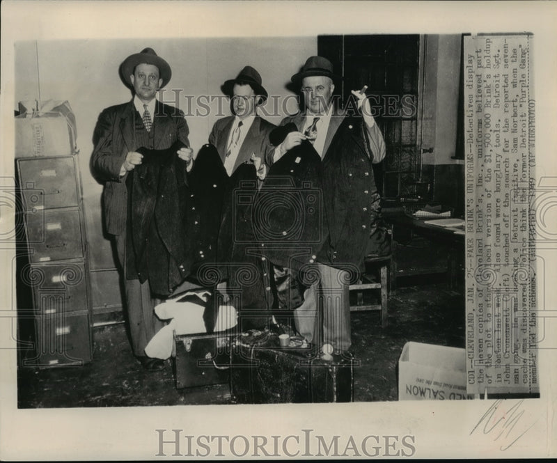Load image into Gallery viewer, 1949 Press Photo Detectives display the seven Cleveland Brink's Inc., uniforms
