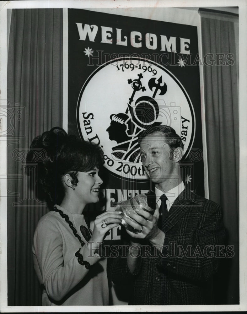 1969 Press Photo Robert P. Knowles, Jr. gives Ginger Crocker a Swiss cowbell- Historic Images