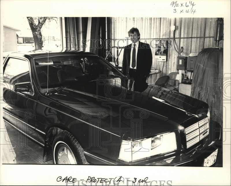 Load image into Gallery viewer, 1987 Press Photo Ziebart manager Steve Geis reflects in glazed hood of car.
