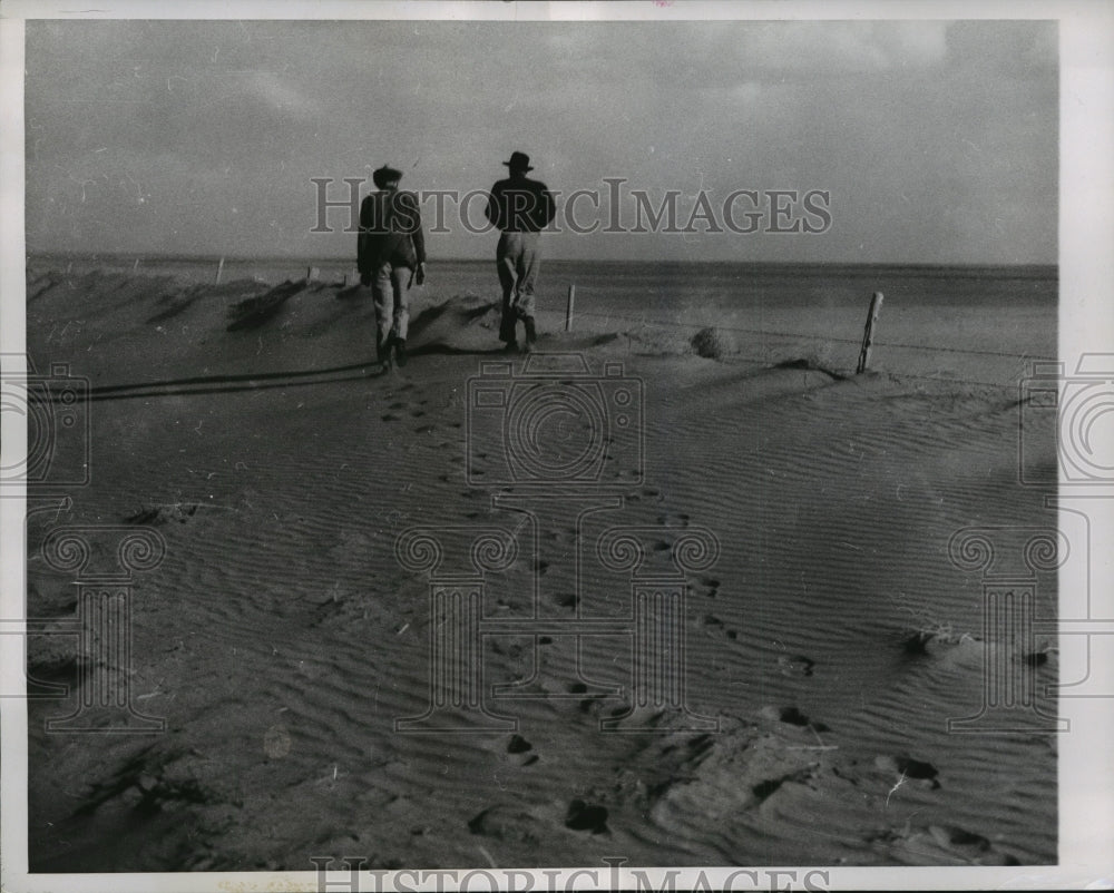 1956 Press Photo Two farmers inspect land near Kit Carson in eastern Colorado