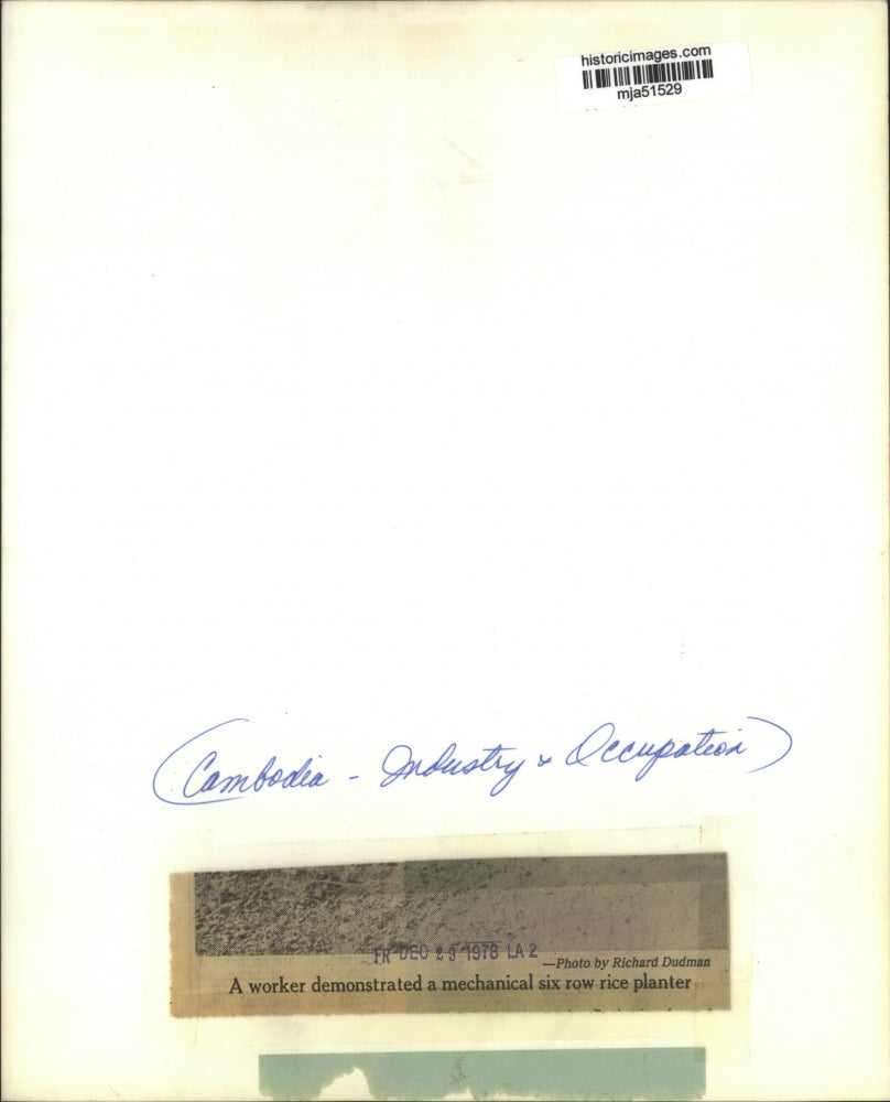 1978 Press Photo A Cambodian worker shown with a mechanical six row rice planter