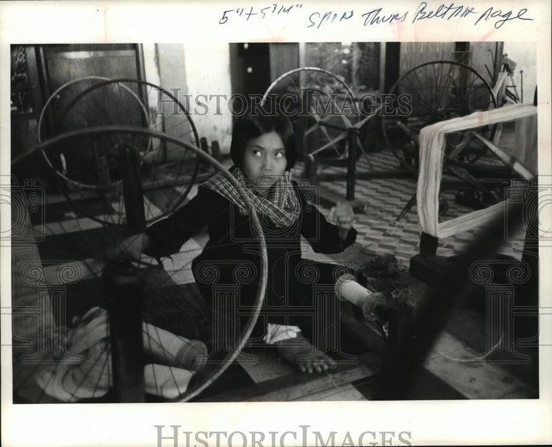 Load image into Gallery viewer, 1978 Press Photo A Cambodian girl operates a spinning at a small textile mill
