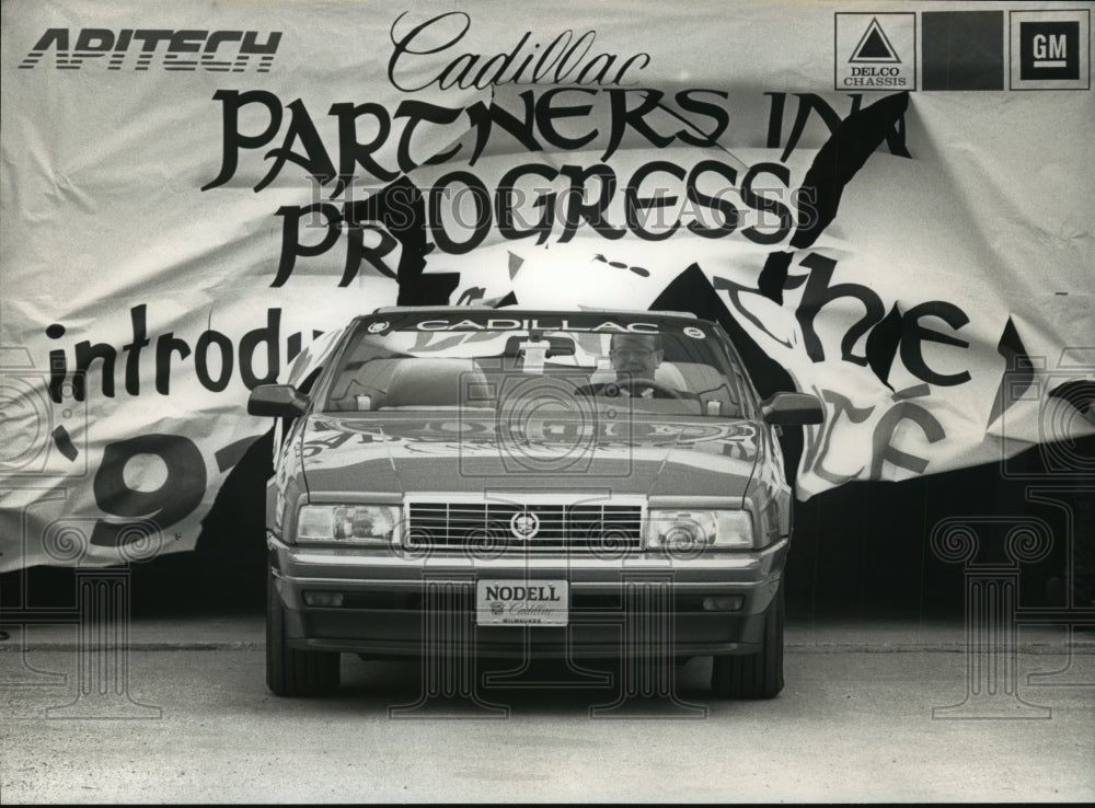 1992 Press Photo Richard Sim Drives Through Banner in Cadillac Allante- Historic Images