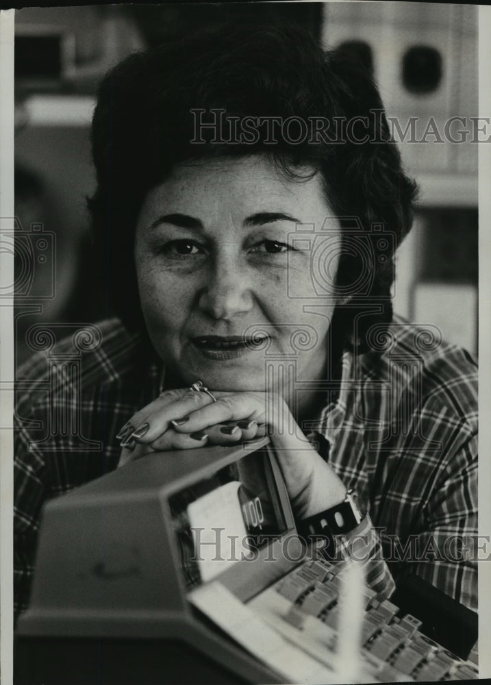 1975 Press Photo Juanita Castro rests on the cash register in a store in Miami- Historic Images