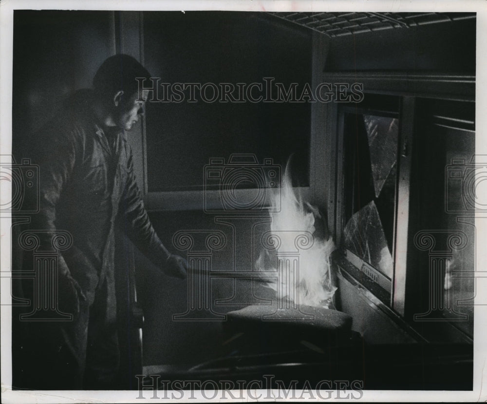 1967 Press Photo Workman igniting the interior of a train car. - Historic Images