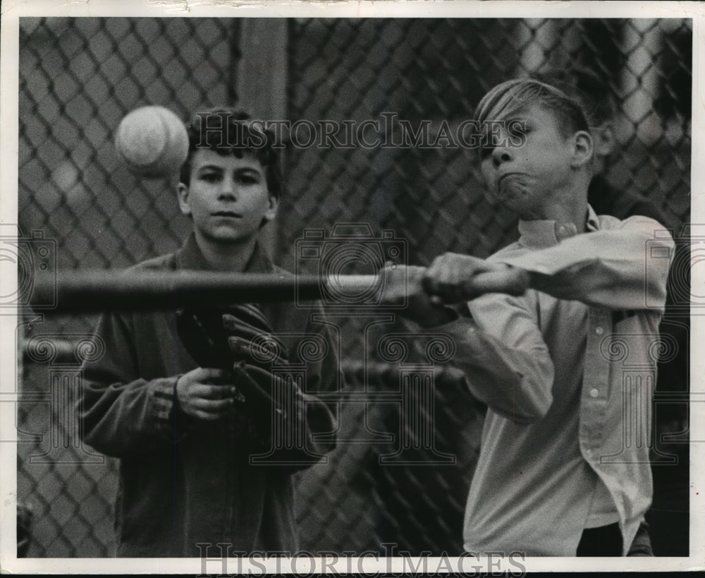 1969 Press Photo Bradley Hermanson swinging at a baseball on the playground- Historic Images