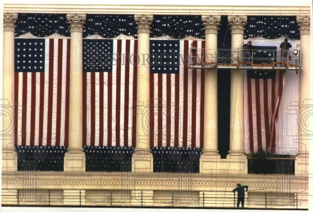 1993 Press Photo Workers hanging historical flags for Clinton inauguration - Historic Images