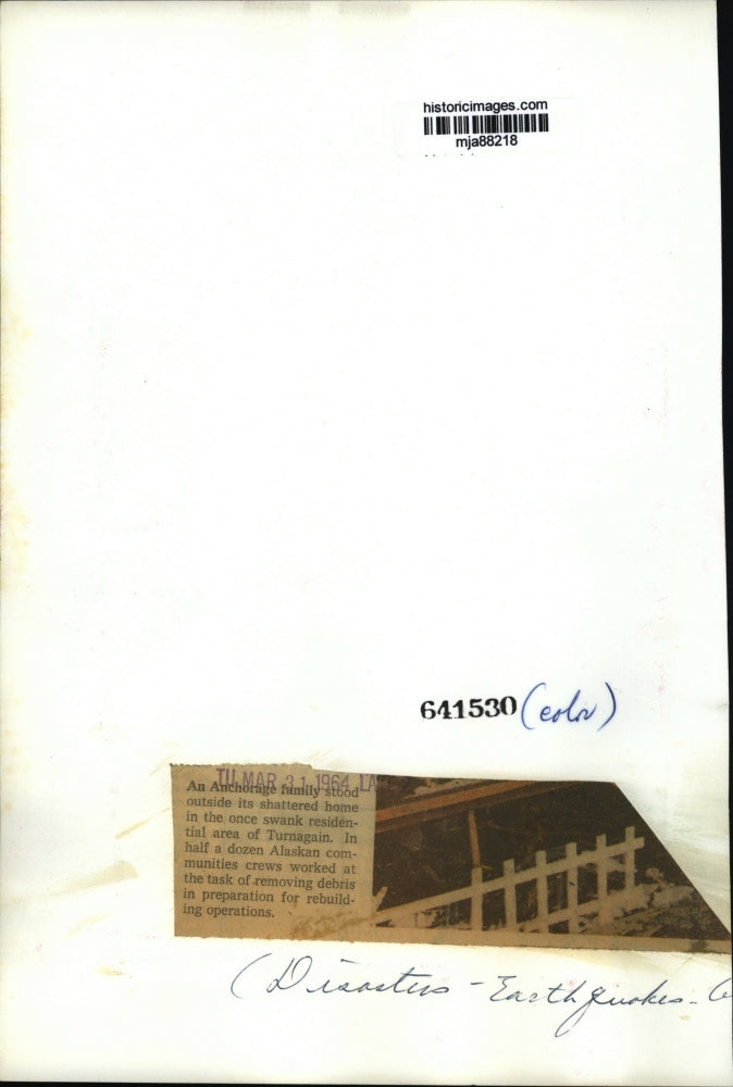 1964 Press Photo Family looks on home after destructive earthquake. Alaska