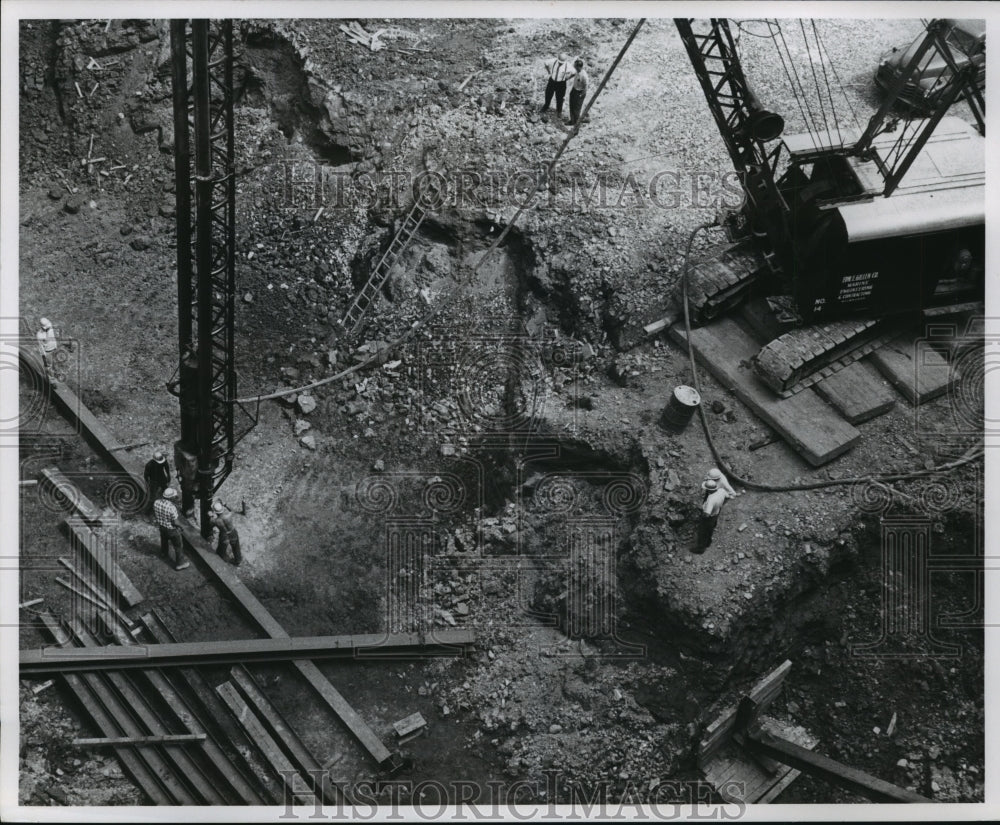 1960 Press Photo Workers stand near crane in building construction site- Historic Images